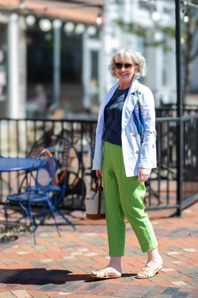 woman with white jacket and green pants