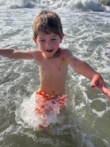 child in waves