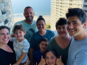 family with beach in the background
