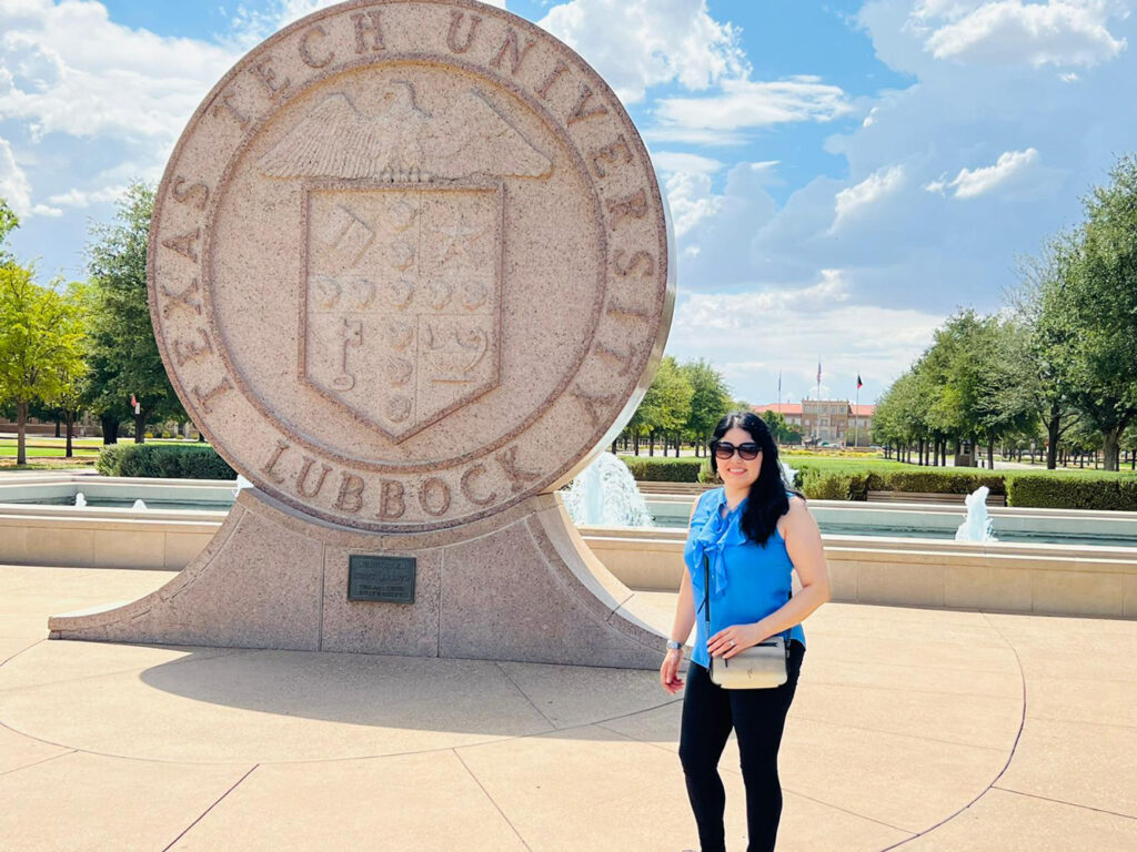 woman in front of Texas Tech logo