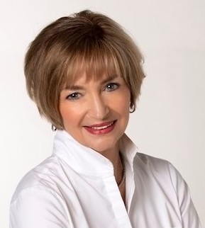 Smiling mature woman in a white blouse