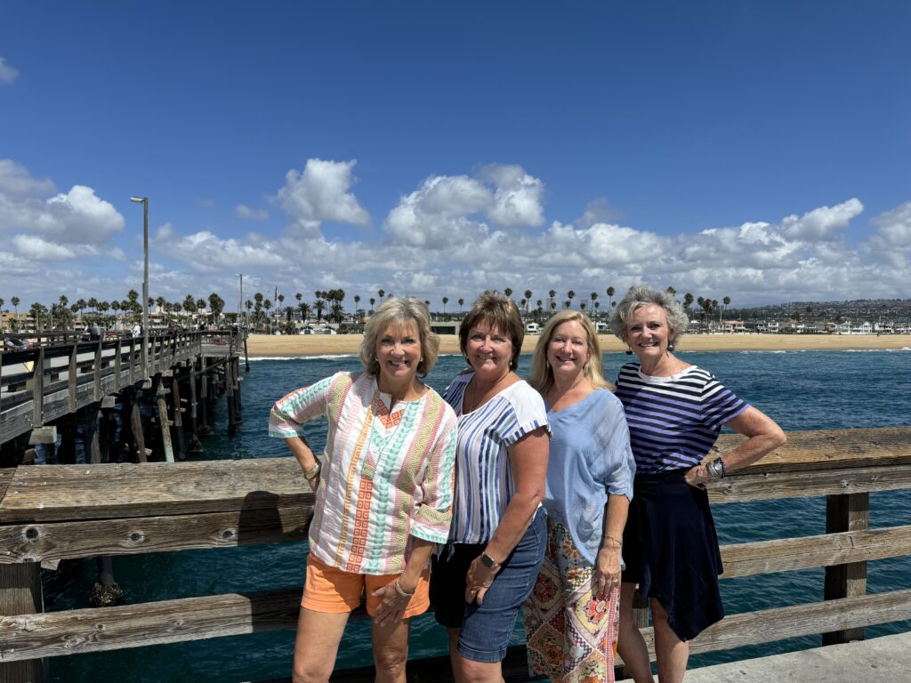4 women on a pier