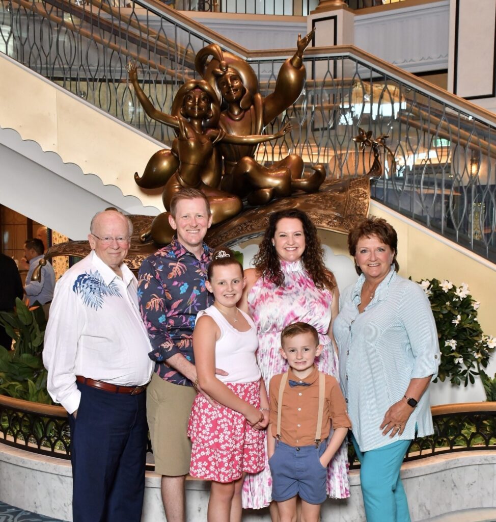 family in front of Aladdin and Jasmine sculpture