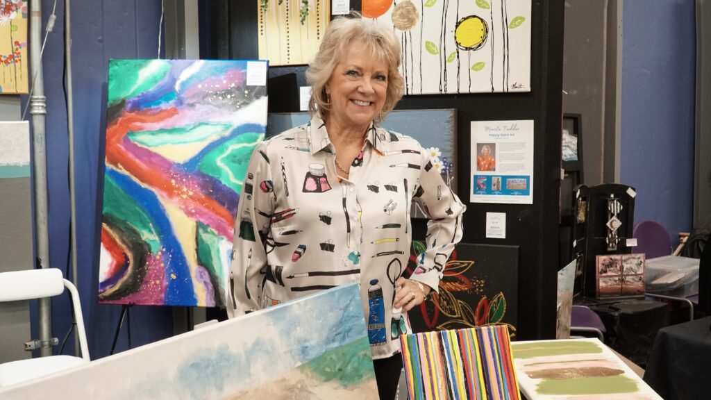 Marita in front of her art