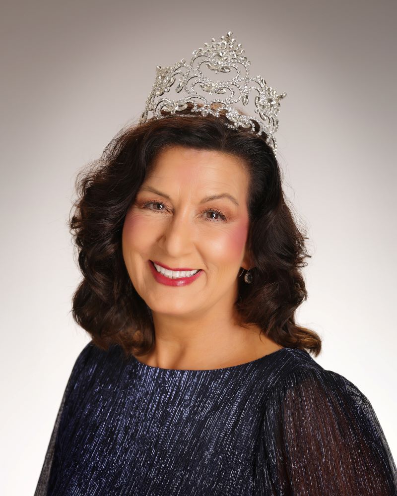 Dark haired woman with crown