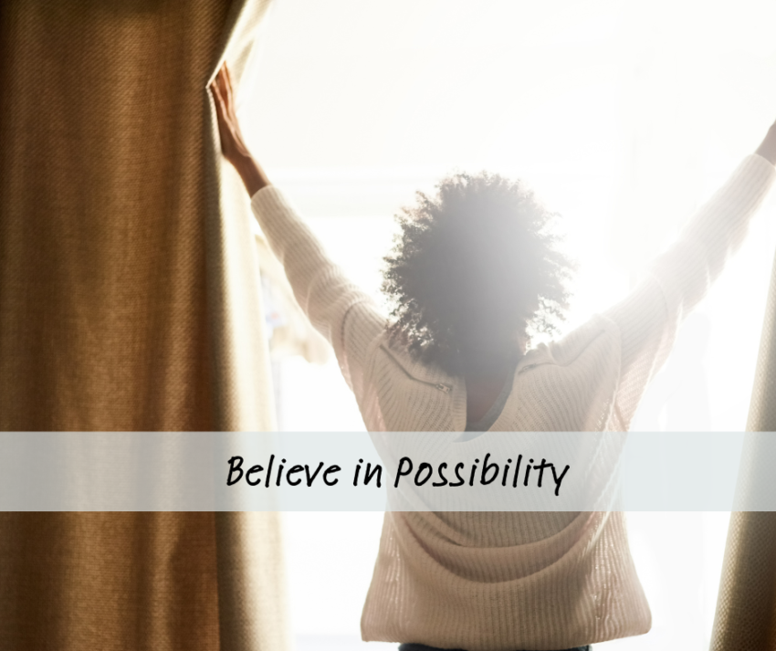 woman opening blinds to a new day