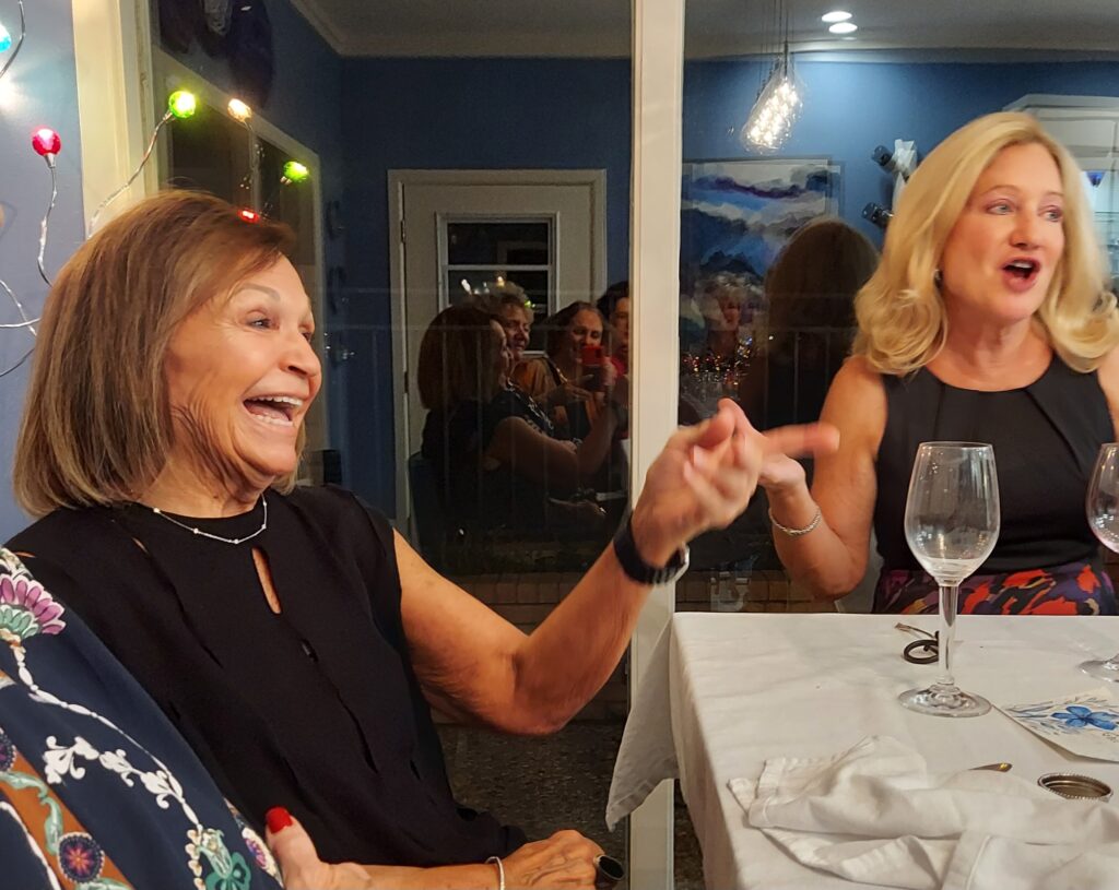 women laughing at dinner table
