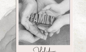 Black and white photograph with hands holding a block that says family